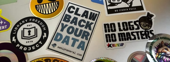 Photo of the back of my laptop with a "Claw Back Your Data" sticker